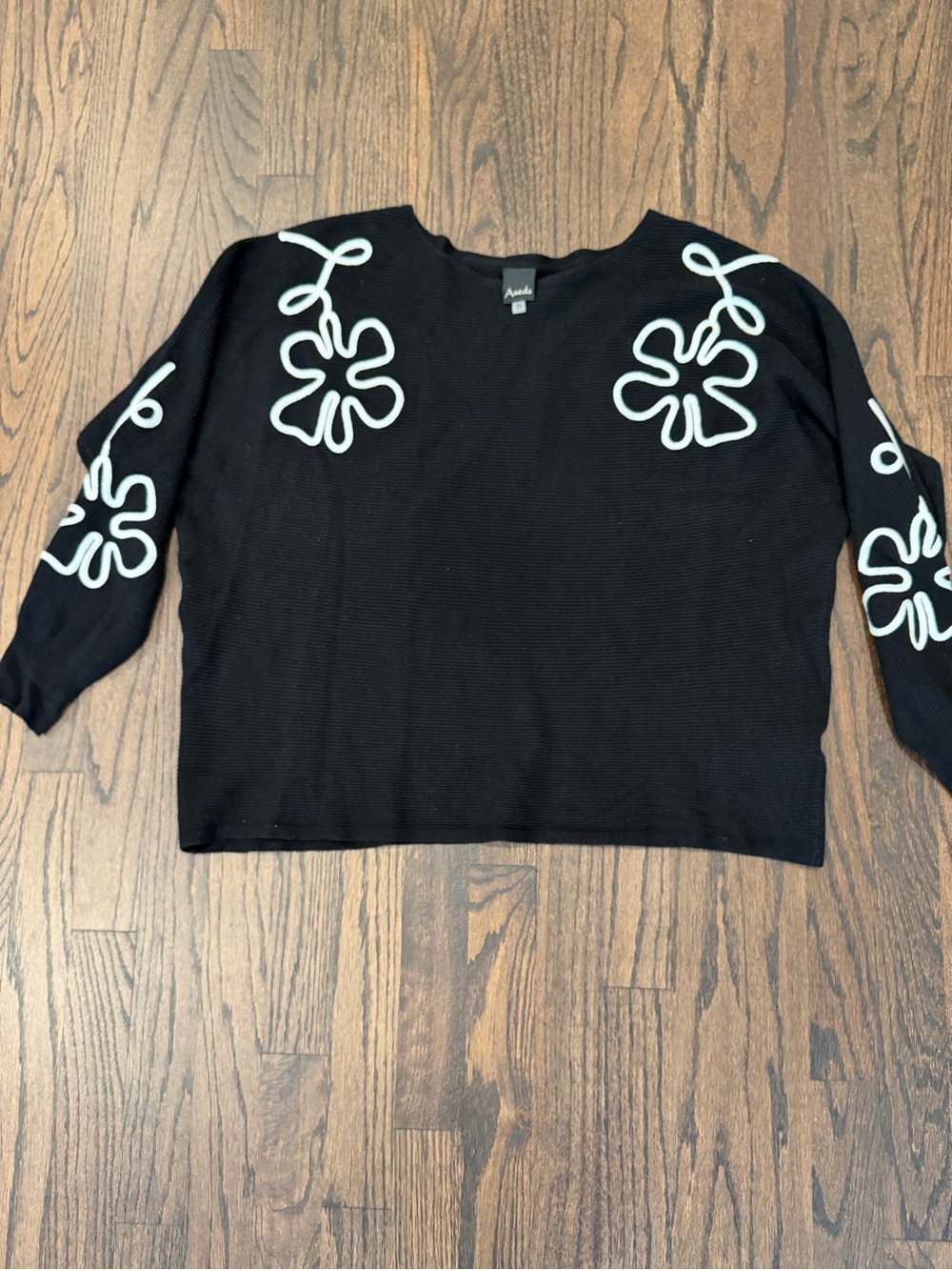 Aaeda Black Crewneck Sweater with White Floral Trim